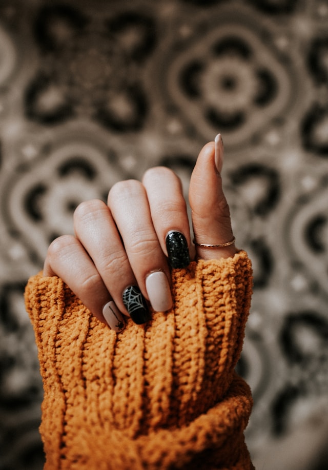 Black statement nail art on knit sweater